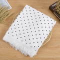 Close-up of double-layer cotton muslin baby blanket with stars and white tassels - White Star