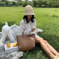 Retro woven straw tote bag with bamboo handles on a sunny lawn picnic setting - Small / Brown
