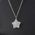 Macro shot of 2.5cm star-shaped natural crystal pendant on silver metal chain - 2.5cm / White Crystal