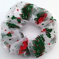 Detail of white mesh scrunchie with Christmas pine and red bow prints on white background - Christmas Leaves