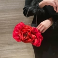 Detail of red rose-shaped satin evening bag with layered petals and metal chain - Red