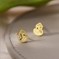 Detailed close-up of 18k gold plated gourd earrings with honeycomb texture on leather - Gourd Shape / Gold