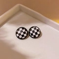 Classic round checkered stud earrings with black and white resin finish on a display - Round Grid Studs / Black & White Check