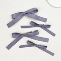 Close-up of four lavender satin bow hair clips showing silky texture and metal duckbill clips - Purple (4pcs Set)