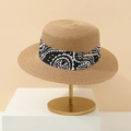 Close-up of a straw boater hat with paisley ribbon on a gold display stand - M (56-58cm) / Caramel color