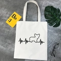 Detail of canvas tote bag with black Corgi silhouette and heartbeat pattern on ivory fabric - Bulldog Corgi Silhouette