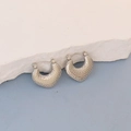 Detail of silver oval hoop earrings with textured finish and lever back closure - Silver Litchi Point Texture