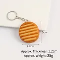 Realistic PVC cookie food keychain with brown baked texture and silver metal ring - Wavy Potato Chip Keychain