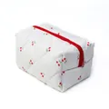 Quilted white travel toiletry bag featuring red cherry patterns and a bold red zipper - White Cherry