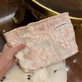 Beige canvas makeup bag with pink floral embroidery and woven brand label on front - Shiny Silk Cherry Blossom Pink
