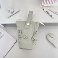 Detailed top view of light green macaron pencil case with bow accents and handle on desk - Light Gray