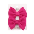 Pair of bright pink textured bubble fabric hair bow clips on white cardboard display - Rose Red