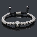 Detail of beaded wolf head bracelet with green zircon eyes and adjustable woven cord - Silver Wolf Head