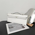 Detailed view of white leather handbag with classic turn-lock strap and top handle - White