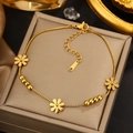 Detail of gold box chain bracelet with daisy charms and polished round beads - Gold Daisy Box Chain (LM717)
