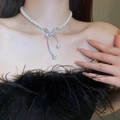 Detail of pearl choker featuring a sparkling diamond-set bow pendant and fringe tassels - White Pearl Bowknot Necklace