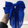 Oversized royal blue bow hair clip made of smooth chiffon fabric held in hand - Sapphire Blue