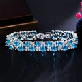 Macro shot of silver bracelet with blue sapphire-like zircons and round cut pavé crystals - Sky Blue