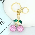 Detailed view of pink rhinestone cherry keychain with green leaves on gold plating - Pink Rhinestone Cherry