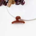 Detailed close-up of a small amber brown jelly hair claw clip with glossy resin finish - Jelly Mini Claw - Straight Deep Orange