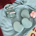 Macro detail of mint heart contact lens case set with mirror, tweezers and accessories - Blue