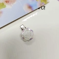 Detail of camellia hair clip with iridescent aurora finish and metal duckbill attachment - Iridescent White