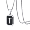 Detail view of a square black pendant with a silver letter T on a stainless steel chain - Letter T