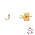 Macro shot of gold-plated S925 sterling silver J-letter and crystal stud earring set - Letter J / Gold