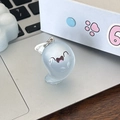 Close-up of translucent light blue ghost keychain charm on a laptop with metal ring detail - Teardrop Ghost