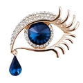 Golden eye-shaped brooch featuring blue faceted crystals and teardrop pendant details - Gold Base Blue Eye