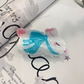 Detail of white rabbit hair claw clip with blue bow design on fashion magazine - White Rabbit with Blue Scarf Claw (approx. 8cm)