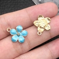 Blue enamel flower pendant and gold metal charm on finger showing petite size - 1Pc Lake Blue Cherry Blossom 14x16mm