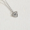 Silver heart necklace with evil eye pendant and blue zircon on textured white wall - Heart Eye Platinum Plated (XL2372)