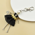 Detail of handmade doll keychain featuring white pearl head and black polka dot mesh skirt - 04-Black Polka Dot Dress Doll