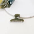 Detailed view of small olive green jelly hair claw clip on a minimalist white plate - Jelly Mini Claw - Straight Olive Green