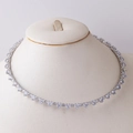 Detail of silver collar necklace with triangular zircon stones on a beige mannequin bust - Triangle Zirconia / Silver