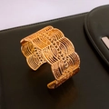 Detailed macro view of the intricate hollow weave texture on this gold cuff bracelet - Gold Hollow Woven Scale Bangle (43#)