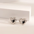 Silver geometric heart stud earrings with hammered finish on minimalist stone display - Multi-faceted Heart / Steel