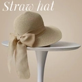 Elegant beige wide-brim straw hat with a delicate bow detail on a minimalist stand - M (56-58cm) / Beige With Bow