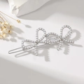 Detail of silver bow hair clip with white pearls on elegant white background with flowers - Pearl Silver