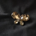 Elegant champagne gold crystal butterfly brooch with sparkling alloy finish on dark velvet - Champagne