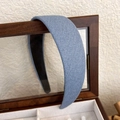 Close-up of blue denim headband with glitter finish on a vintage wooden box - Light Blue Denim