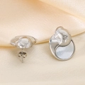 Detail view of silver crescent shell earrings with brushed texture on beige silk fabric - Steel Color (KE115271-K)