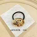 Irregular gold punk metal hair clip with black elastic band in a textured finish - Oval Liquid