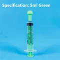 Green 5ml oral medicine syringe with clear black scales on blue grid background - 5ml Green Independent Packaging