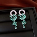 Macro detail of silver tassel earrings with green teardrop gemstones and zircon stones - Silver Earring Post - Silver - Green