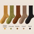 Five pack of women's ribbed cotton mid-calf socks in ginger, green, brown, camel, and black - One Size