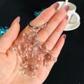Close-up of translucent candy-colored gummy bear charms on a metallic keychain - White