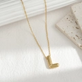 Minimalist gold necklace featuring a 3D chubby letter L pendant on a sleek chain - Letter L