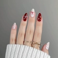 Close-up of red and white press-on nails with bow and polka dot patterns on hands - Bz1655 Spotted Bow Tie / Glue Type